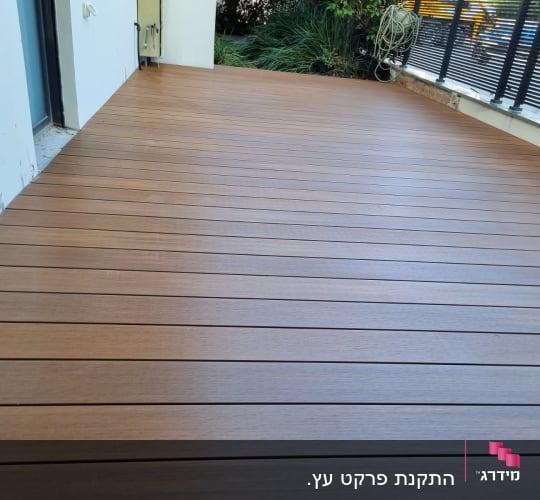 wooden deck with plants and railing